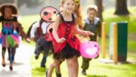 Children In Fancy Costume Dress Going Trick Or Treating Running
