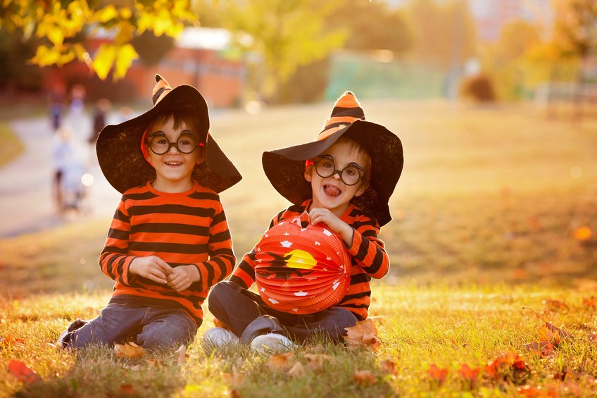 Two boys in the park with Halloween costumes, having fun