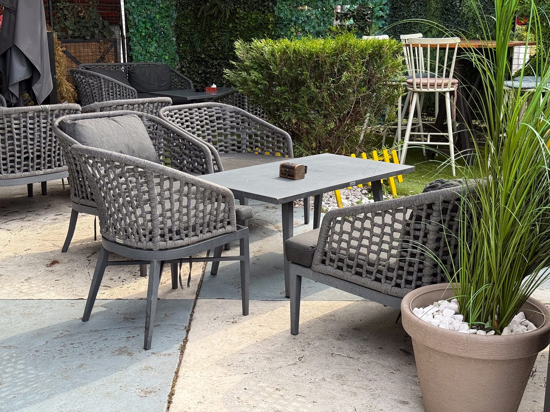 Outdoor cafe seating with woven chairs — best patio furniture stores in Florida