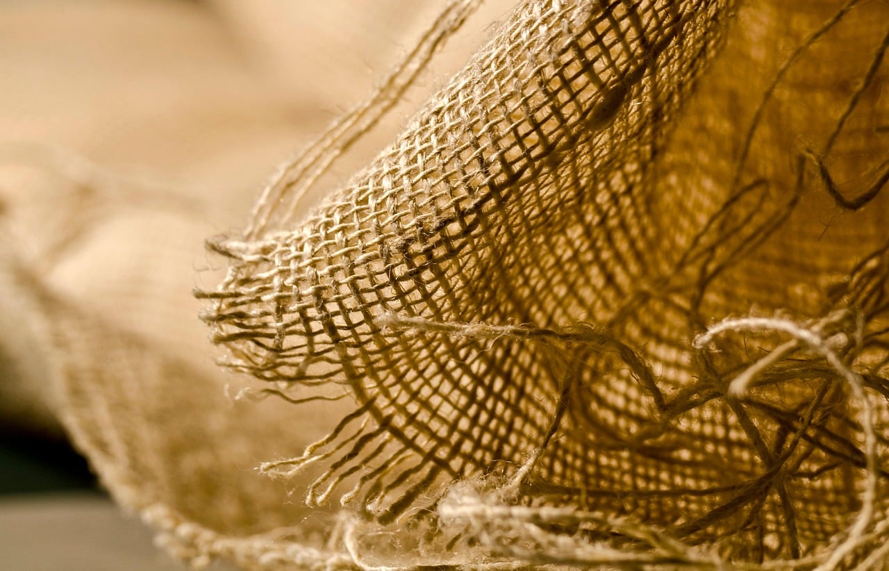 Close-up of outdoor pillow fabric texture showing tightly woven weave resistant to moisture