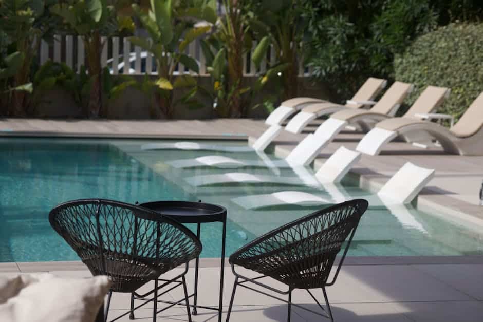 Close-up of powder-coated aluminum patio furniture frame showing smooth finish on a Florida pool deck