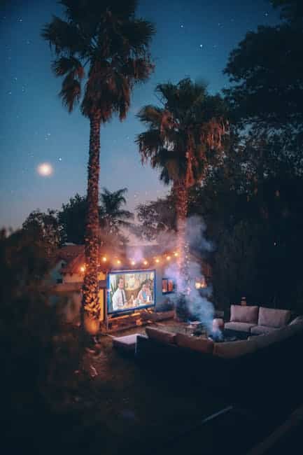 Outdoor sectional arranged in a U-shape for a backyard movie night patio setup in Florida