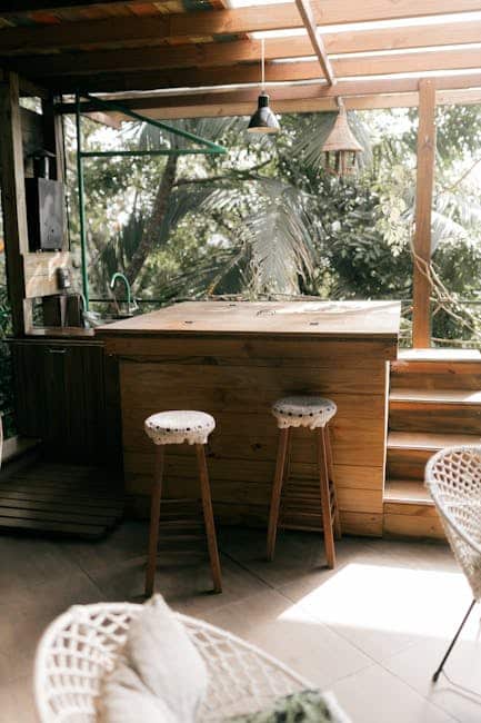 Powder-coated aluminum bar stools positioned at an outdoor kitchen counter on a Florida patio
