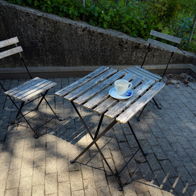Small bistro table and two chairs arranged as a coffee patio nook just outside a Florida kitchen door
