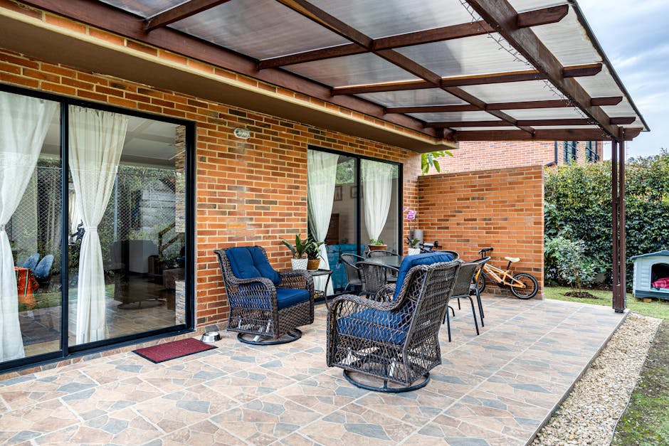 All-weather resin wicker chairs on a tile-pattern stamped concrete patio in Florida