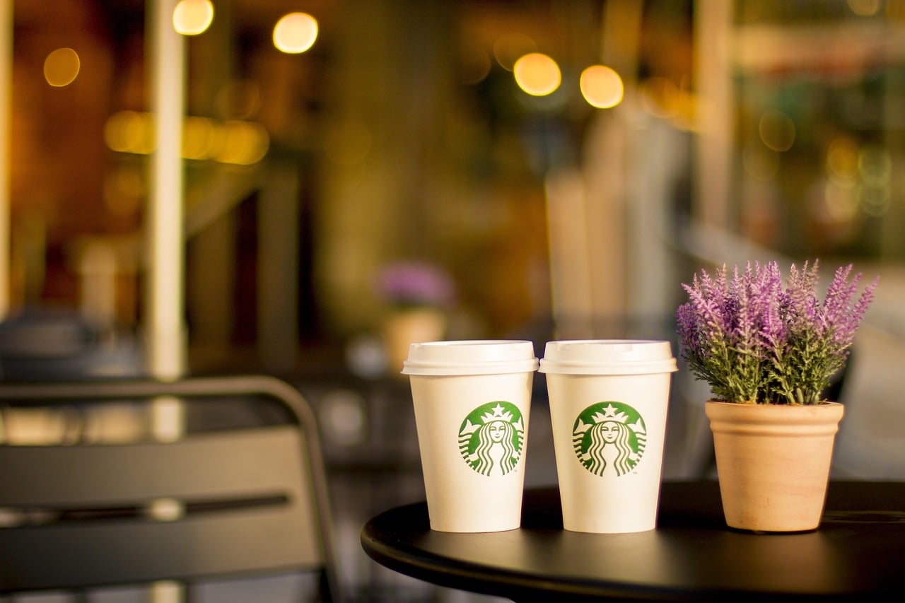 Bar-height outdoor seating arrangement on a Florida patio with coffee and morning light
