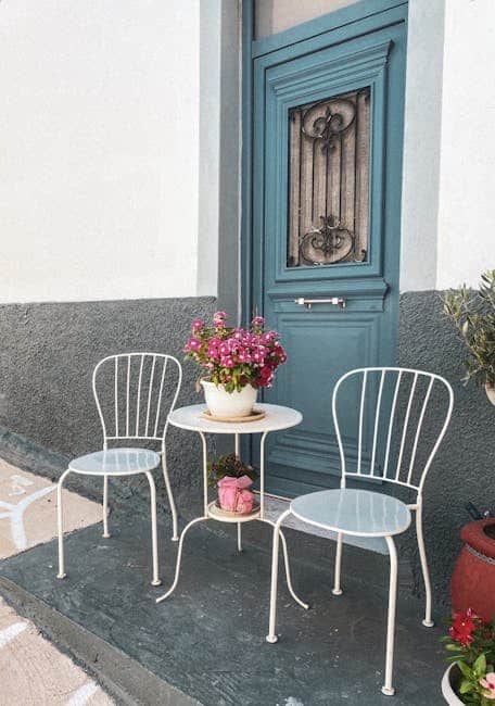 Compact patio set on a Florida townhouse courtyard with a bistro table and two chairs beside a sliding glass door