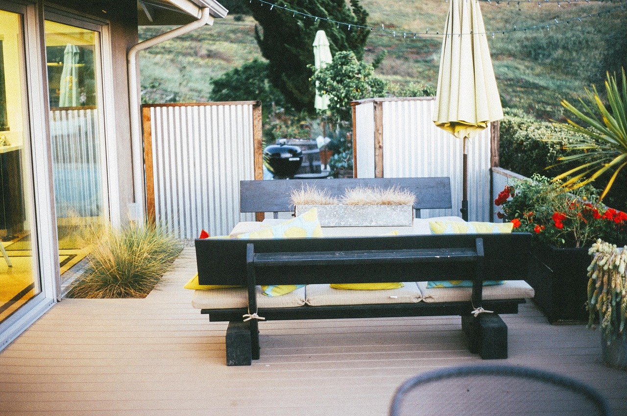 Patio dining set under a large offset cantilever umbrella on a Florida backyard patio