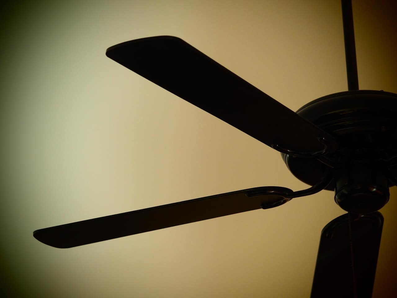 Screened Florida lanai with ceiling fan and outdoor seating arrangement