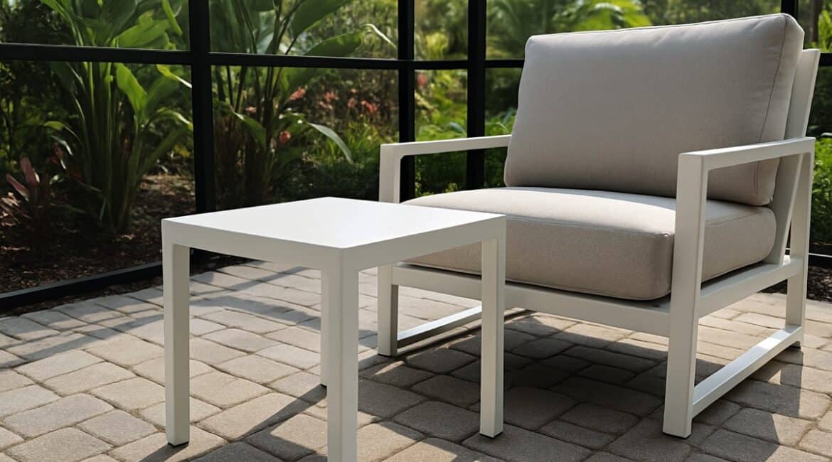 Powder-coated aluminum patio side table and matching deep-seat lounge chair on a Florida screened lanai