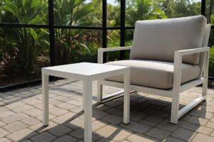 Powder-coated aluminum patio side table and matching deep-seat lounge chair on a Florida screened lanai