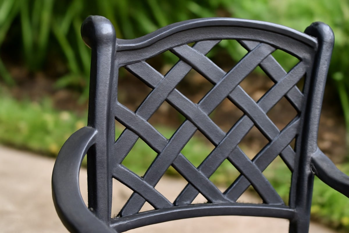 Lightweight aluminum patio chairs arranged on a screened Florida lanai