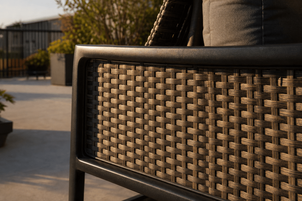 Close-up of HDPE woven wicker furniture detail showing tight weave pattern and powder-coated aluminum frame
