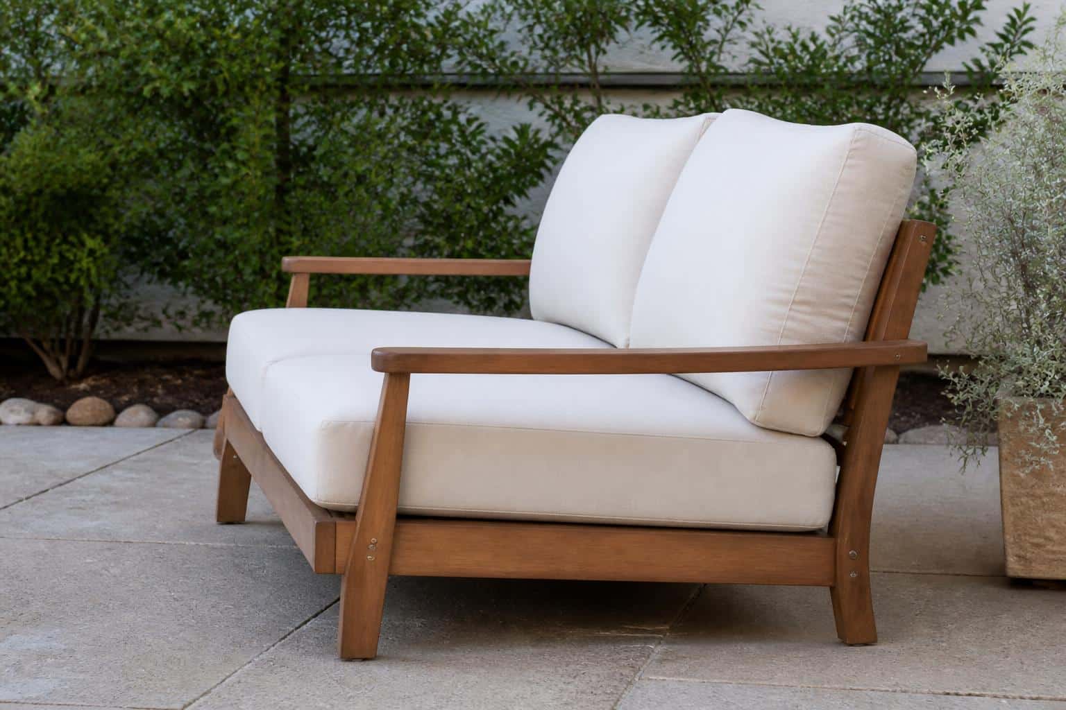 Outdoor loveseat with deep cushions on a covered Florida patio