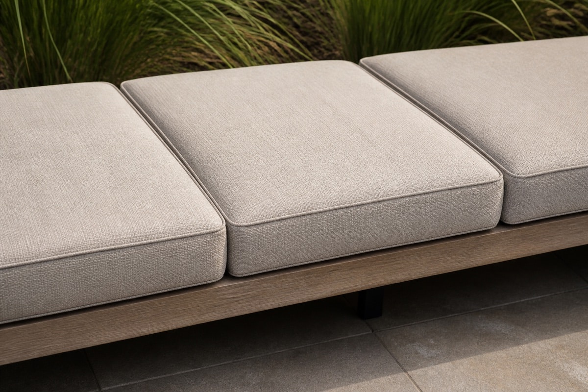 individual outdoor sofa cushions arranged on a patio sofa near a pool deck