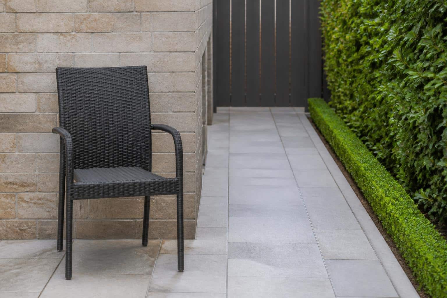 Aluminum stackable dining chairs nested together on a Florida patio