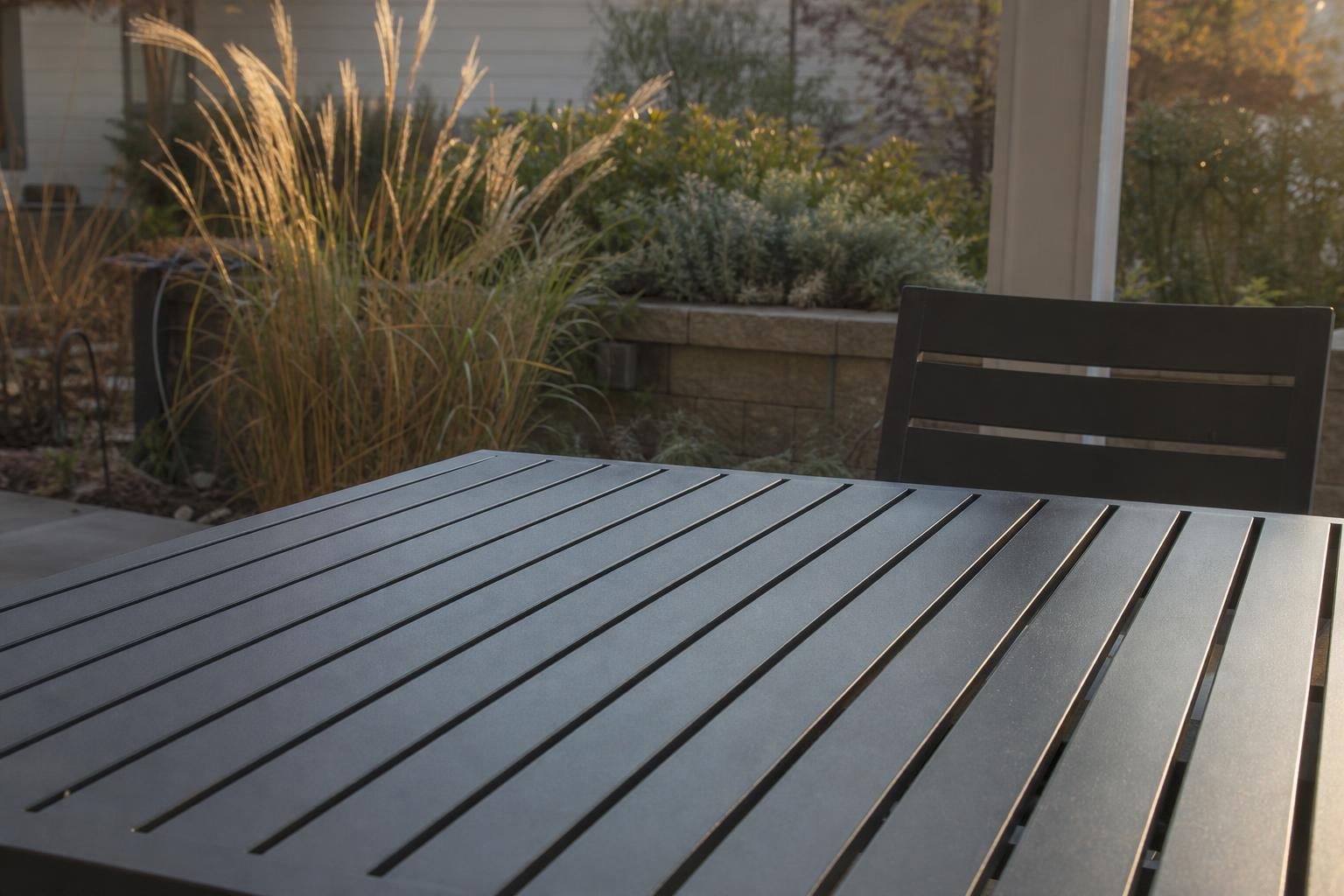 Close view of a slatted aluminum patio table top
