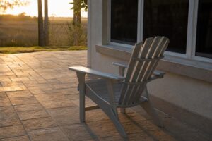 Aluminum Adirondack chair with wide armrests on a Florida patio