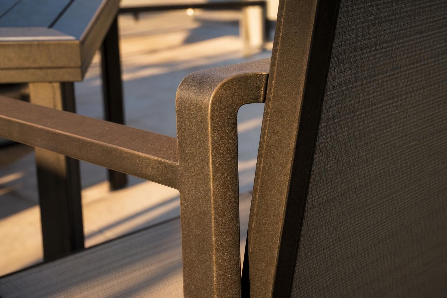Close detail of a powder-coated aluminum patio chair frame finish, showing texture and color
