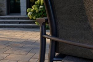 Aluminum patio dining chair frame where the arm meets the back leg