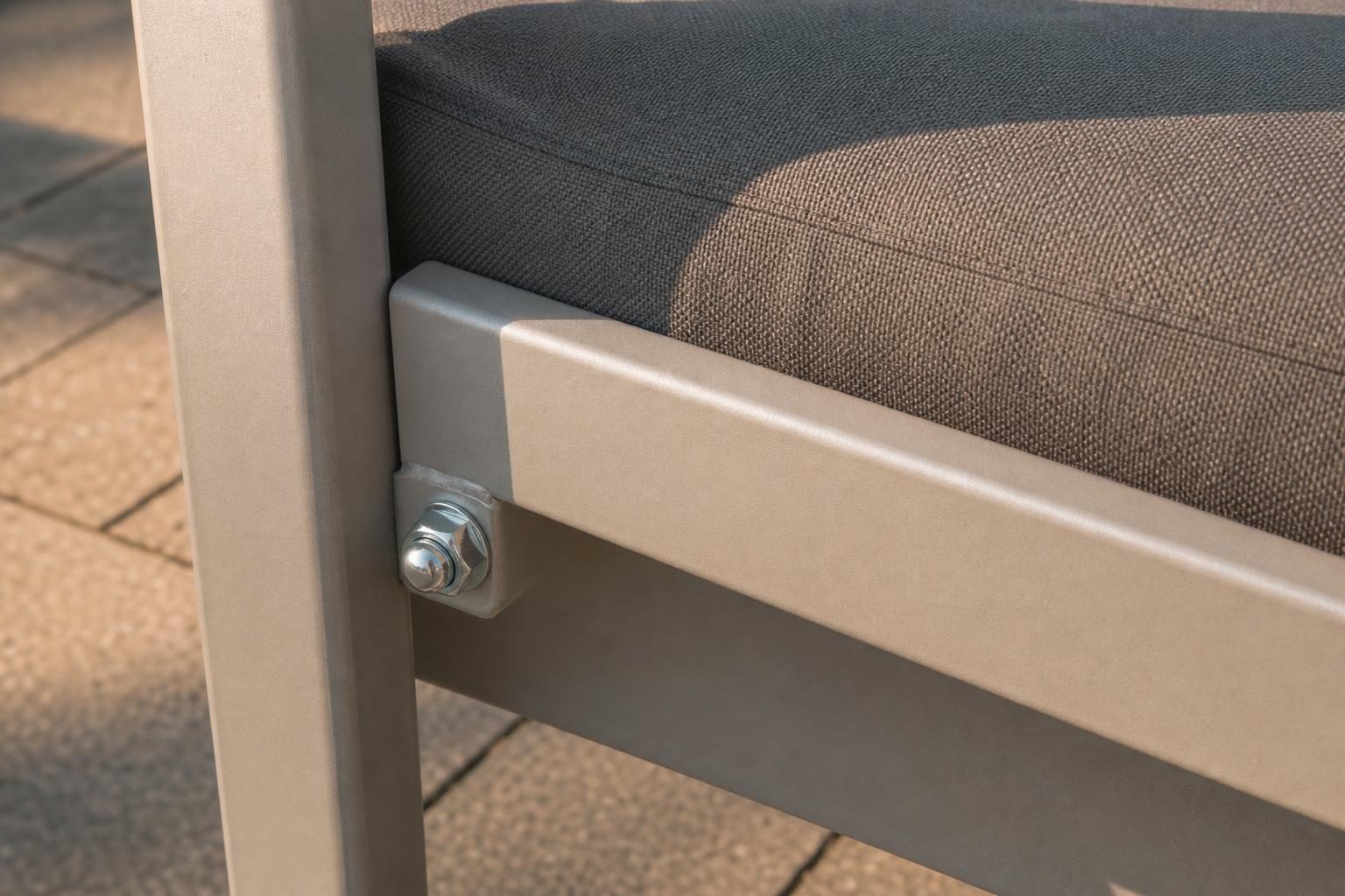 Close view of a bolt and nut joining two aluminum frame pieces