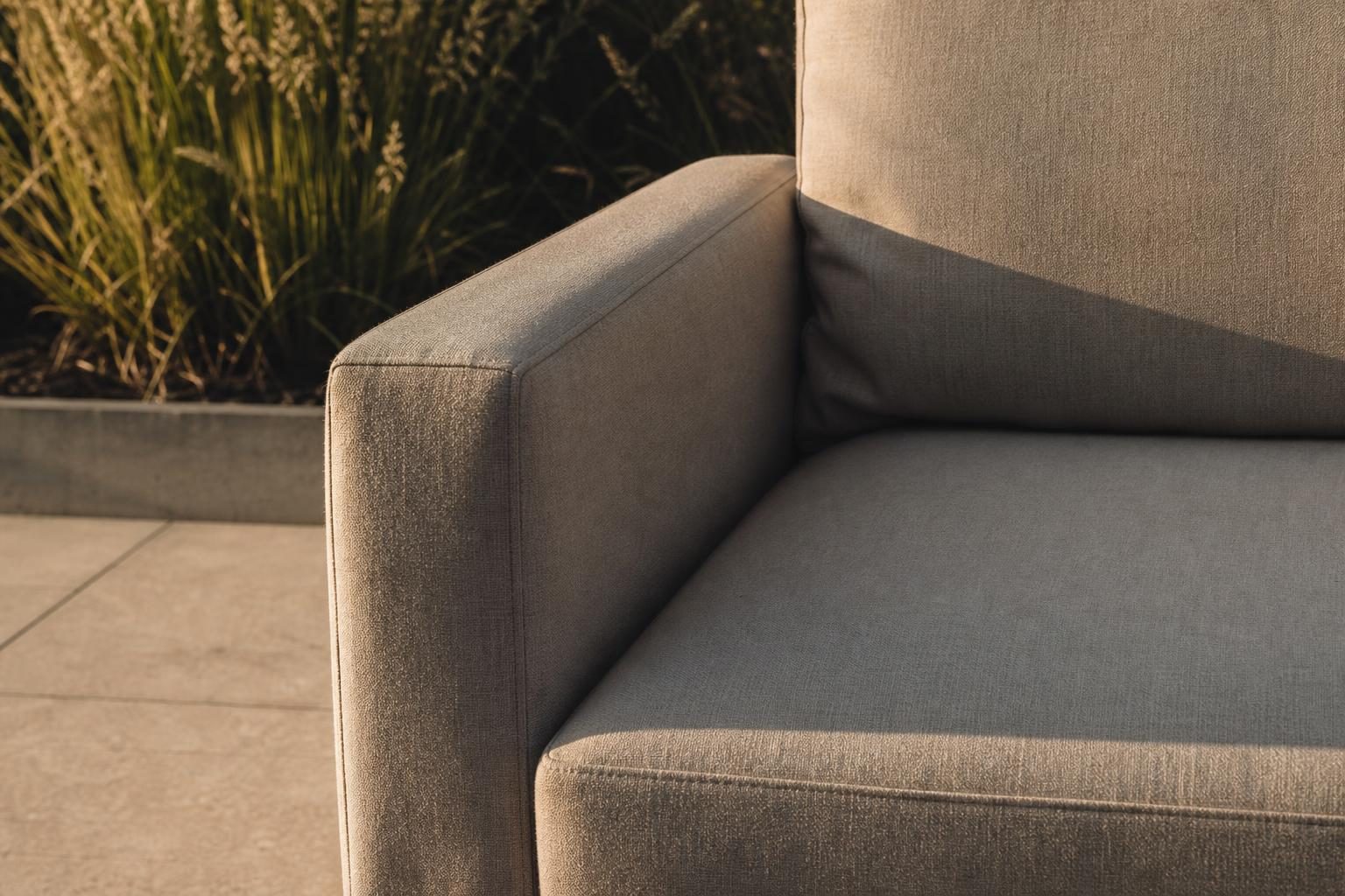 Close view of an outdoor sofa arm meeting the seat cushion