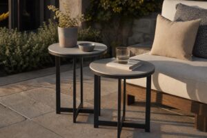 Pair of small round side tables of different heights beside a patio sofa