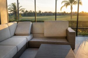 Outdoor sectional with a seat cushion lifted off to show the seat base underneath
