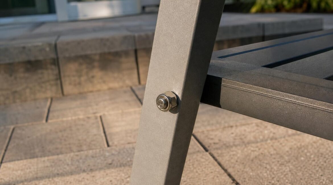Bolt and nut joining an aluminum patio chair leg to the seat frame